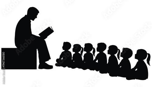A teacher reading a book to a group of children in silhouette