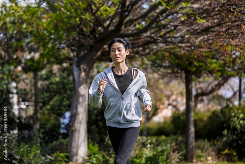 Young woman runs in a park in Spain during daytime