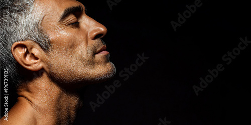 Mature man with skin covered in cosmetic serum for hydrating treatment. Relaxed male profile shot in spa salon. Anti age skincare, cosmetology routine and healthy self care concept.