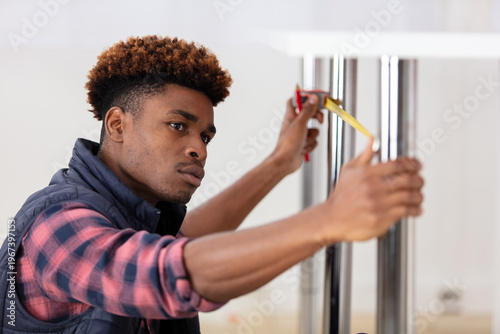 Canvas Print contractor young repairman assembling furniture