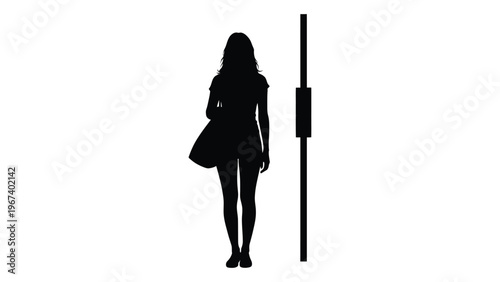Silhouette of a woman standing near a street light or pole