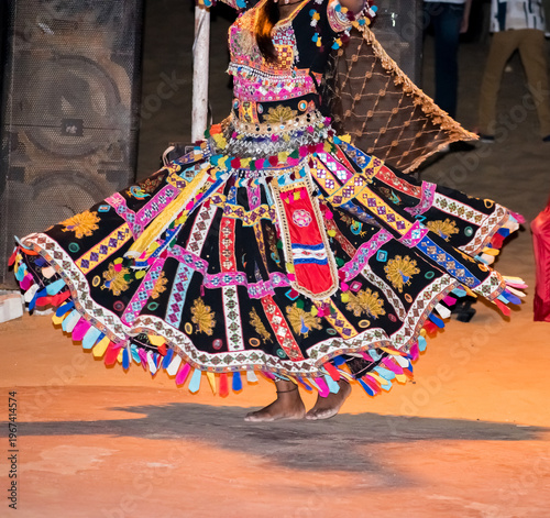 female dancer performing traditional Kalbelia dance in Rajasthan, India. vibrant ethnic costume with flowing skirt capturing movement, culture and folk heritage. 