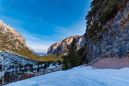 Tableau sur toile Winding Switchback Road in the Dolomites near Pederü with Snowy Peaks