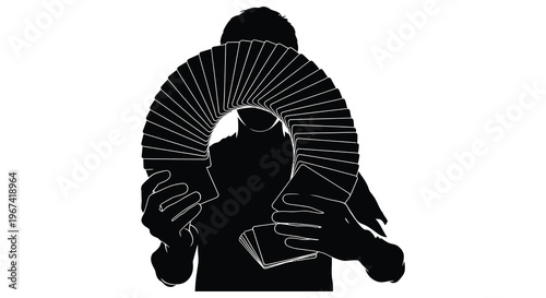Magician displaying a fan of cards in a dramatic silhouette