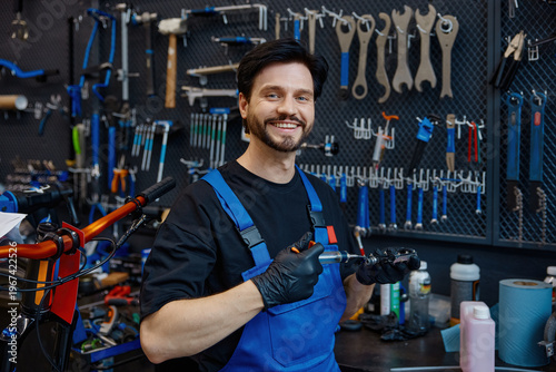 Customer-oriented repair expert presenting completed handlebar assembly with friendly demeanor
