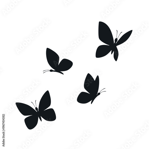 Four black butterfly silhouettes are elegantly displayed in various flight and resting poses, isolated on a clean white background for versatile design use