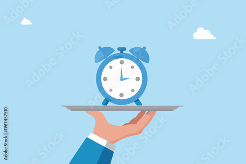 A blue alarm clock is presented on a silver tray by a hand