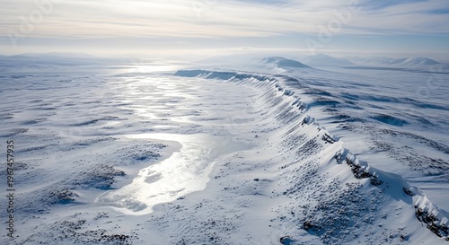 Vast Snowy Mountain Ridge Under a Bright Sky with Distant Sunlit Ice Formations