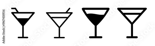Set of four martini cocktail glasses with different liquid levels and straws