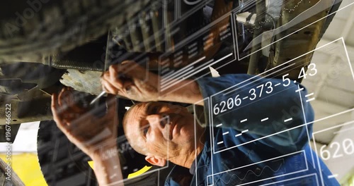 Mechanic placing wrench under car in shop, tightening bolts securing part with HUD overlaying