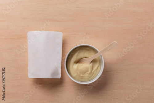 Still Life Pack Shot of Empty Baby Food Packaging with Product Sample