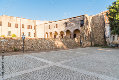 Wallpaper Mural The Cloister of San Francesco with remains of the Pisan Walls, attached to the convent of the Church of San Francesco, located in the historic center of Iglesias, Sardinia, Italy. Torontodigital.ca