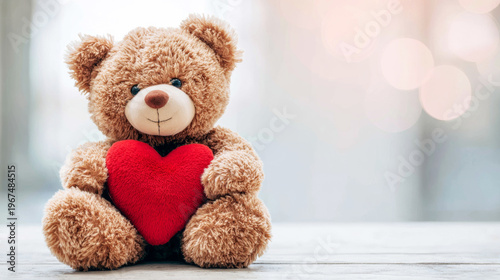 Cute teddy bear sitting on a wooden surface, hugging a red heart, symbolizing affection, warmth, and friendship