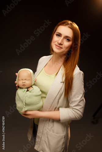 Woman Holding Newborn Baby Mannequin for Photography Practice