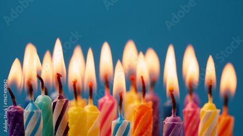 Group of Colorful Candles Burning Brightly for a Birthday Celebration on a Bl...