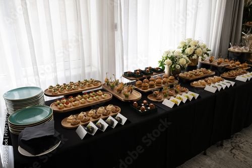Canvas-taulu Elegant buffet table with plated desserts and appetizers at a catered event rece