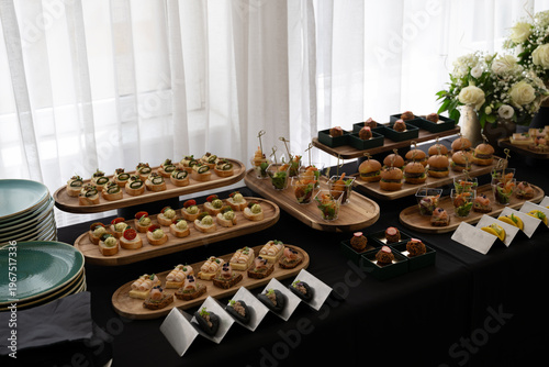 Obraz na plátně Elegant buffet table with plated desserts and appetizers at a catered event rece