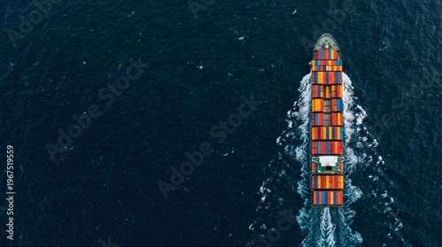 Aerial top view of container ship with colorful cargo sailing on ocean