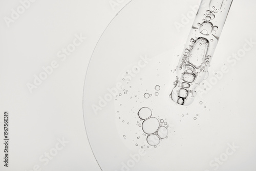 Cuadro en lienzo Dropper releasing clear liquid with bubbles, highlighting serum texture and puri