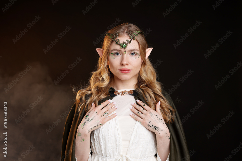 Obraz premium Beautiful elf girl on black background with smoke