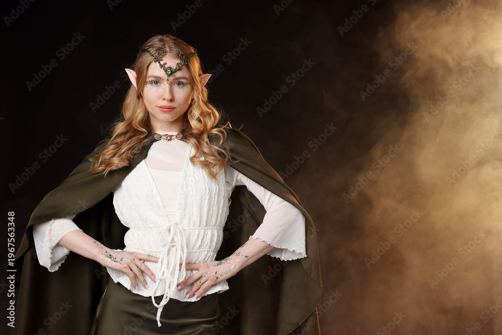 Obraz premium Beautiful elf girl on black background with smoke, space for text
