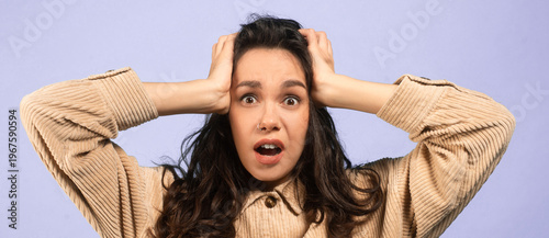 Canvastavla A woman expresses strong surprise and shock by holding her head with both hands