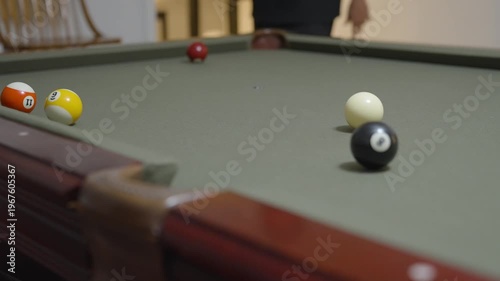Close-up of a Man Playing Billiards and Pocketing a Ball