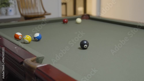 Close-up of a Man Playing Billiards and Pocketing a Ball