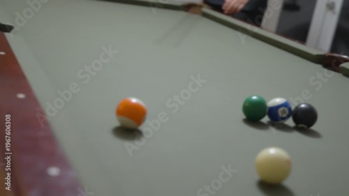 Close-up of a Man Playing Billiards and Pocketing a Ball