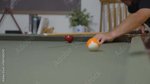 Close-up of a Man Playing Billiards and Pocketing a Ball