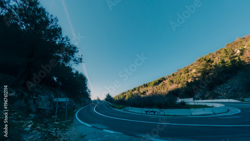 Winding mountain road in Croatia with forest and rocky terrain