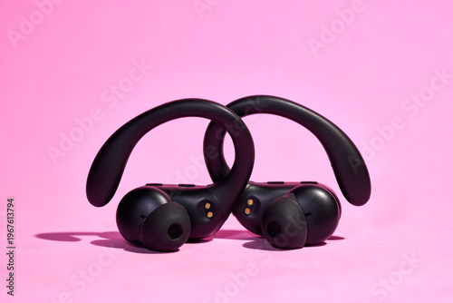 Detailed view of ergonomic  headphones on a pink background in product style