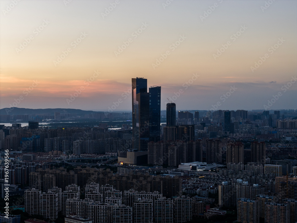 Obraz premium Aerial view of modern city at sunset