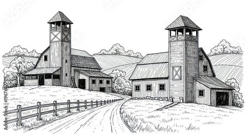 Two rustic barns with tall towers and a dirt road leading to them.