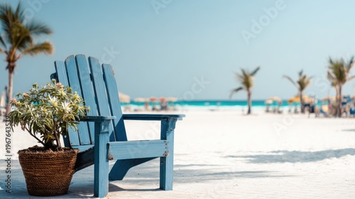 Blue chair on sandy beach with palm trees and ocean view on sunny day