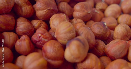 Peeled hazelnut kernels lie on a plate. Close-up