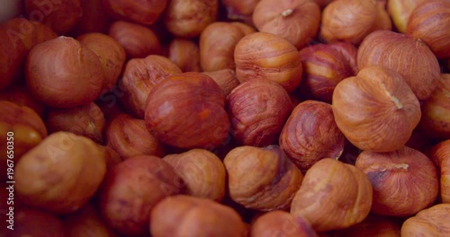 Peeled hazelnut kernels lie on a plate. Close-up