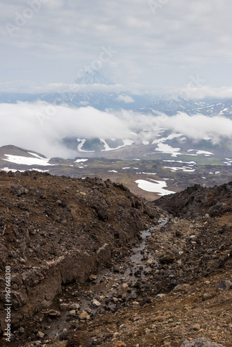 View from Gorely volcano to Vilyuchinsky volcano, Kamchatka Territory, Russia. Mountain landscape. Travel, tourism and hiking on the Kamchatka Peninsula. Beautiful nature of the Russian Far East.