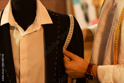 Male tailor measuring jacke...