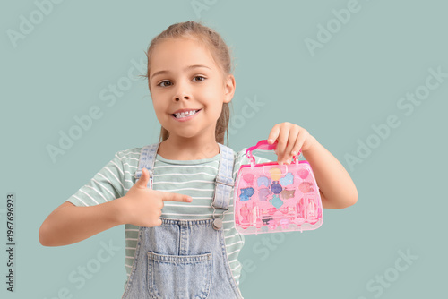 Cute little girl pointing a...