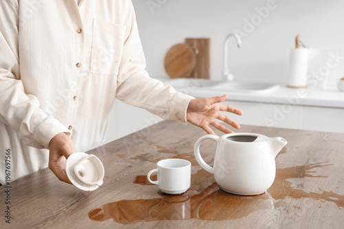 Woman with cup, pot and spi...