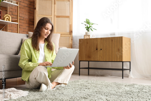 Young woman using laptop on...