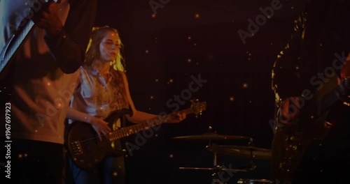 Camera widening guitarist strumming,singing at vintage mic while bassist plucking, performing music