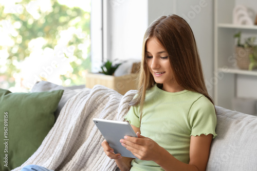 Teenage girl using tablet c...