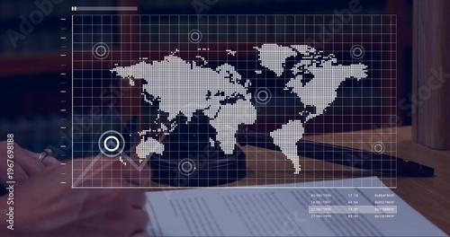 Overlaying faint world map over wooden desk in law office showing gavel document ring dark sleeve