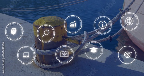 Securing yellow bollard anchoring thick braided ropes on pier, with boat hull and digital icons