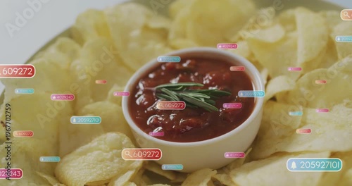 Vertical video: Badges appearing and clustering around white bowl of salsa with chips and rosemary