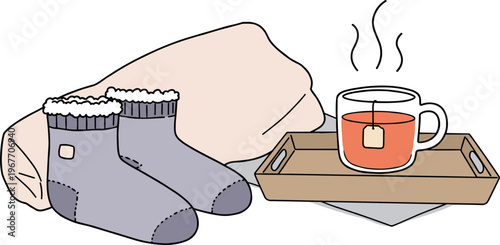 Cozy socks and a cup of tea on a wooden tray with a warm blanket