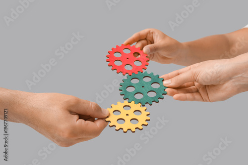 Hands with colorful gears o...