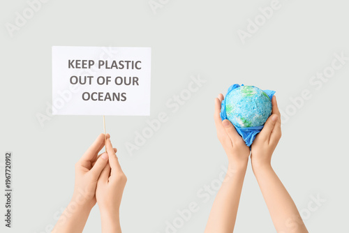 Hands holding paper sheet w...